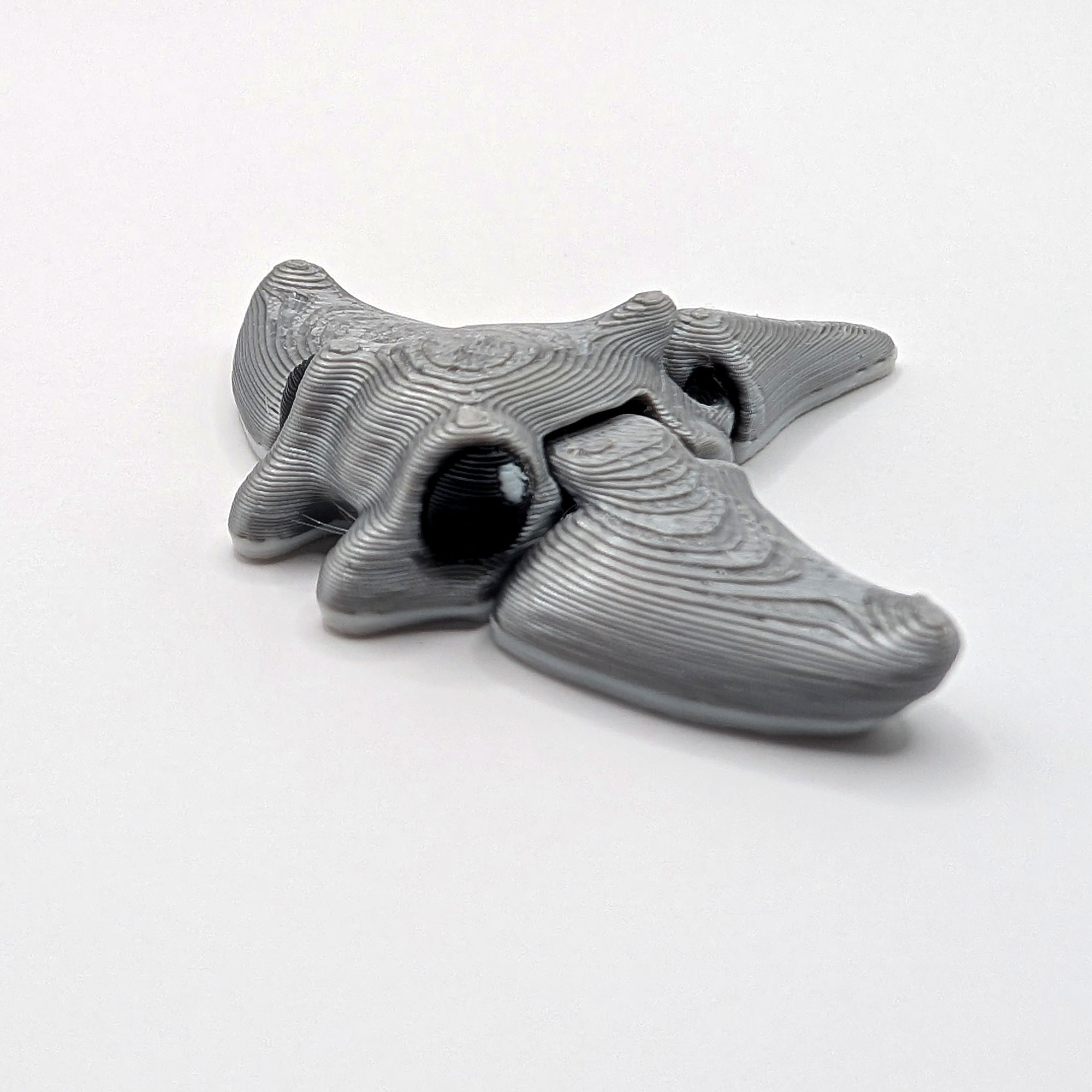 Grey manta ray Hatchling articulated 3D-printed fidget companion, three-quarter view