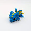 Blue and yellow Dragon Hatchling articulated 3D-printed fidget companion, three-quarter view