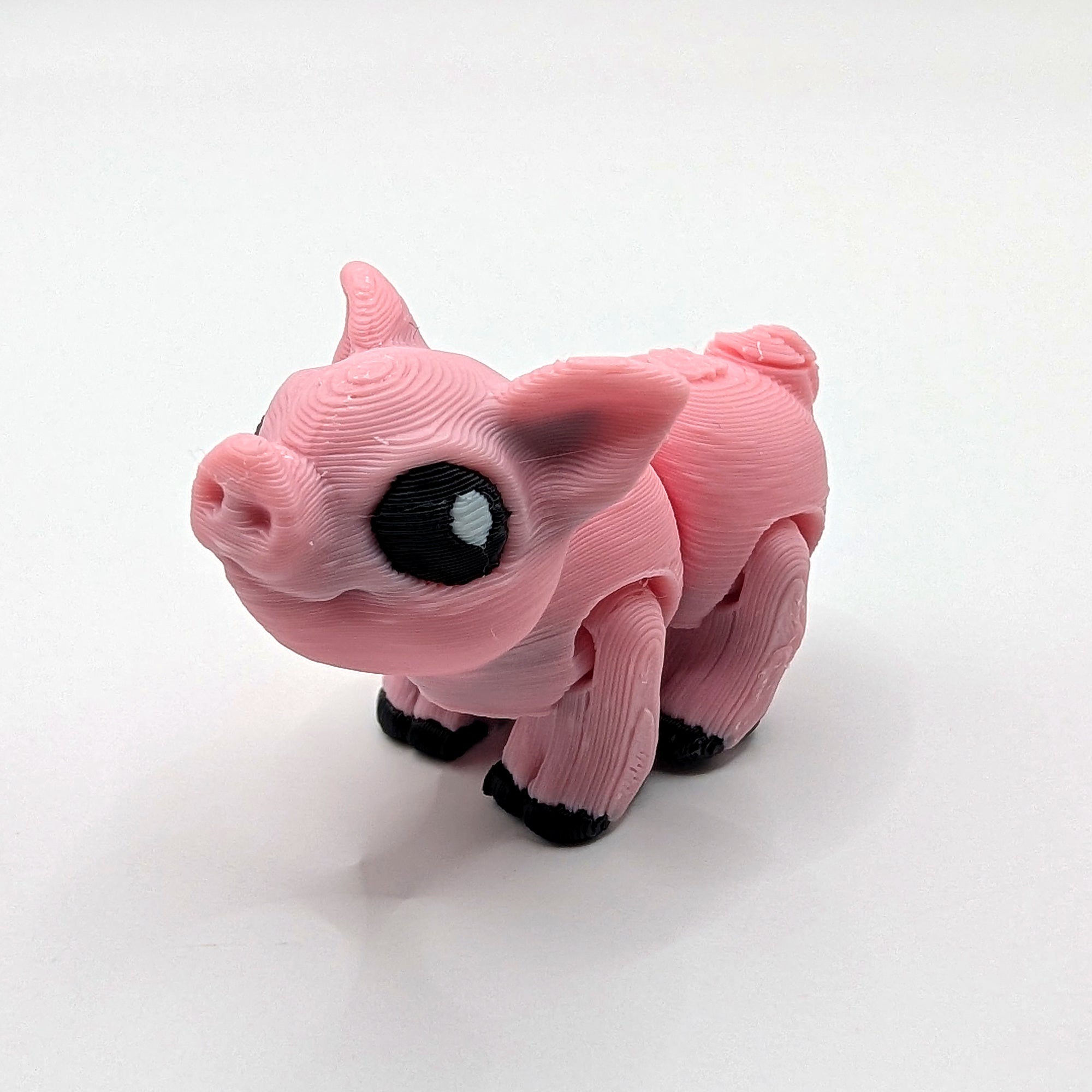 Pink pig Hatchling articulated 3D-printed fidget companion on a white background