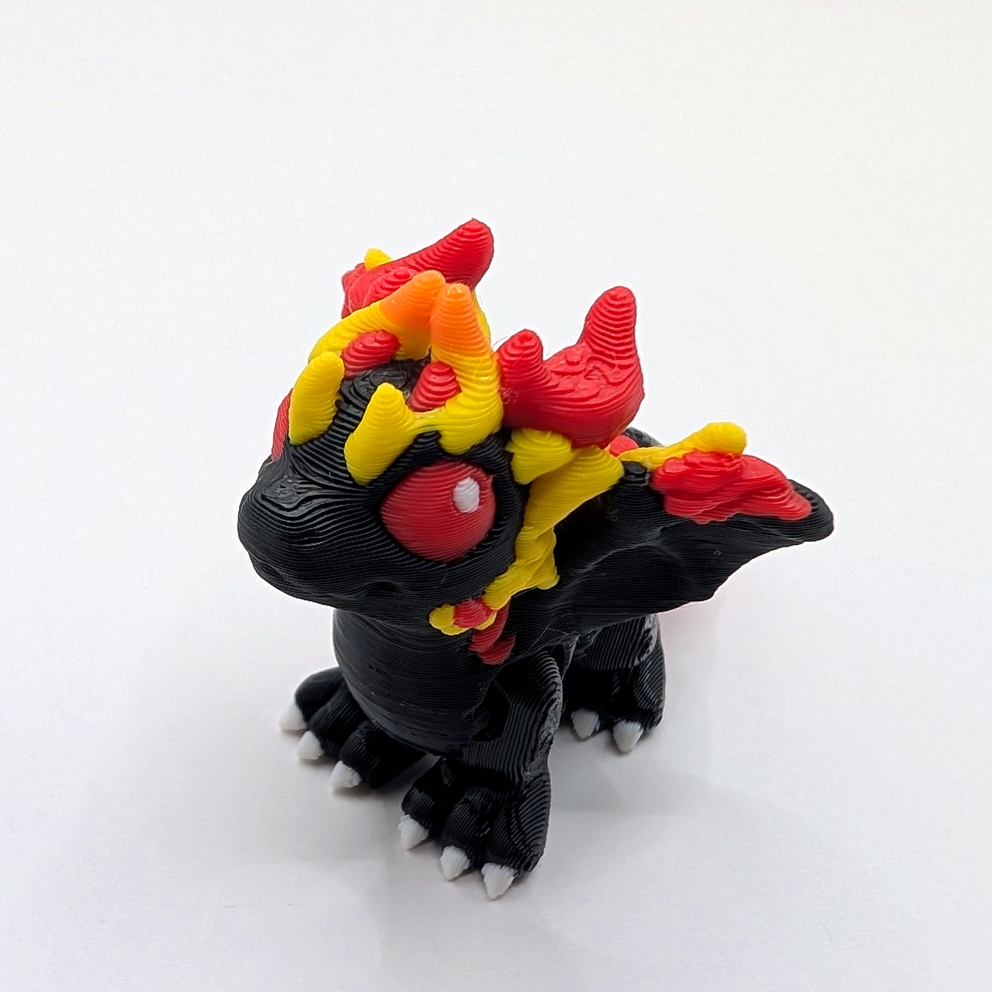 Black and flame-coloured Fire Dragon Hatchling articulated 3D-printed fidget companion