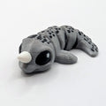 Grey narwhal Hatchling with white tusk, articulated 3D-printed fidget companion