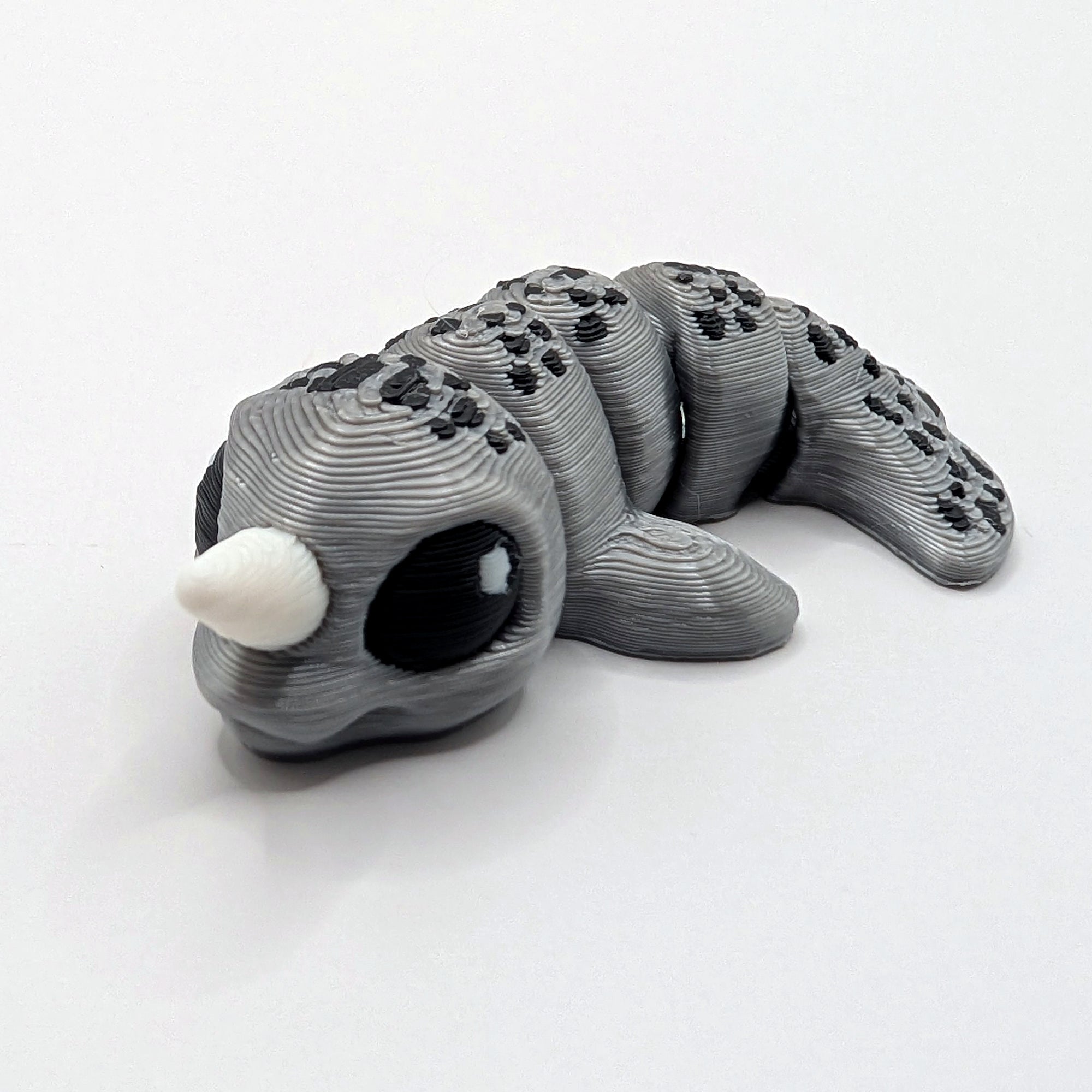 Grey narwhal Hatchling with white tusk, articulated 3D-printed fidget companion
